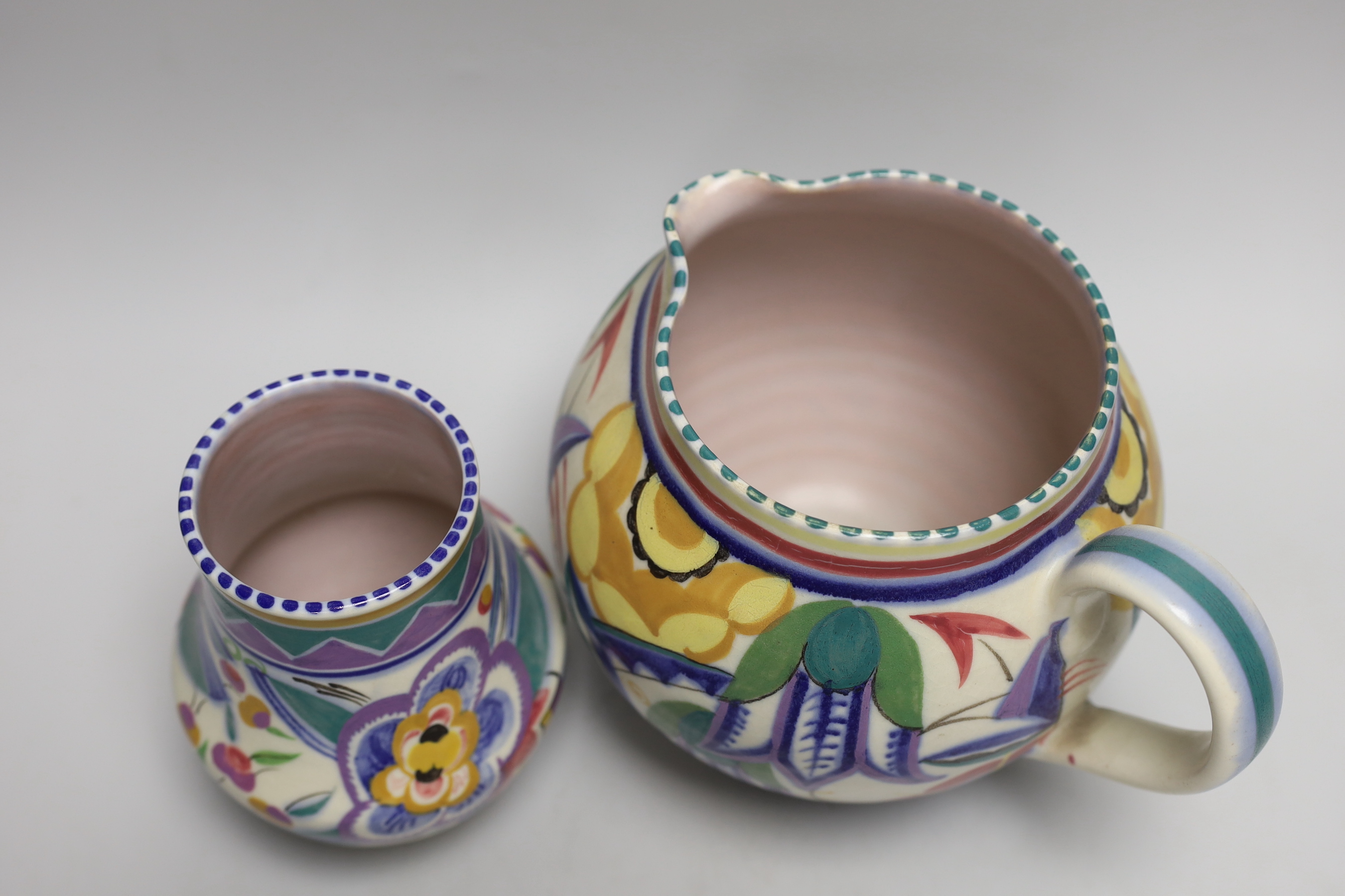 A 1930’s Poole Pottery polychrome jug and vase, jug 16cm